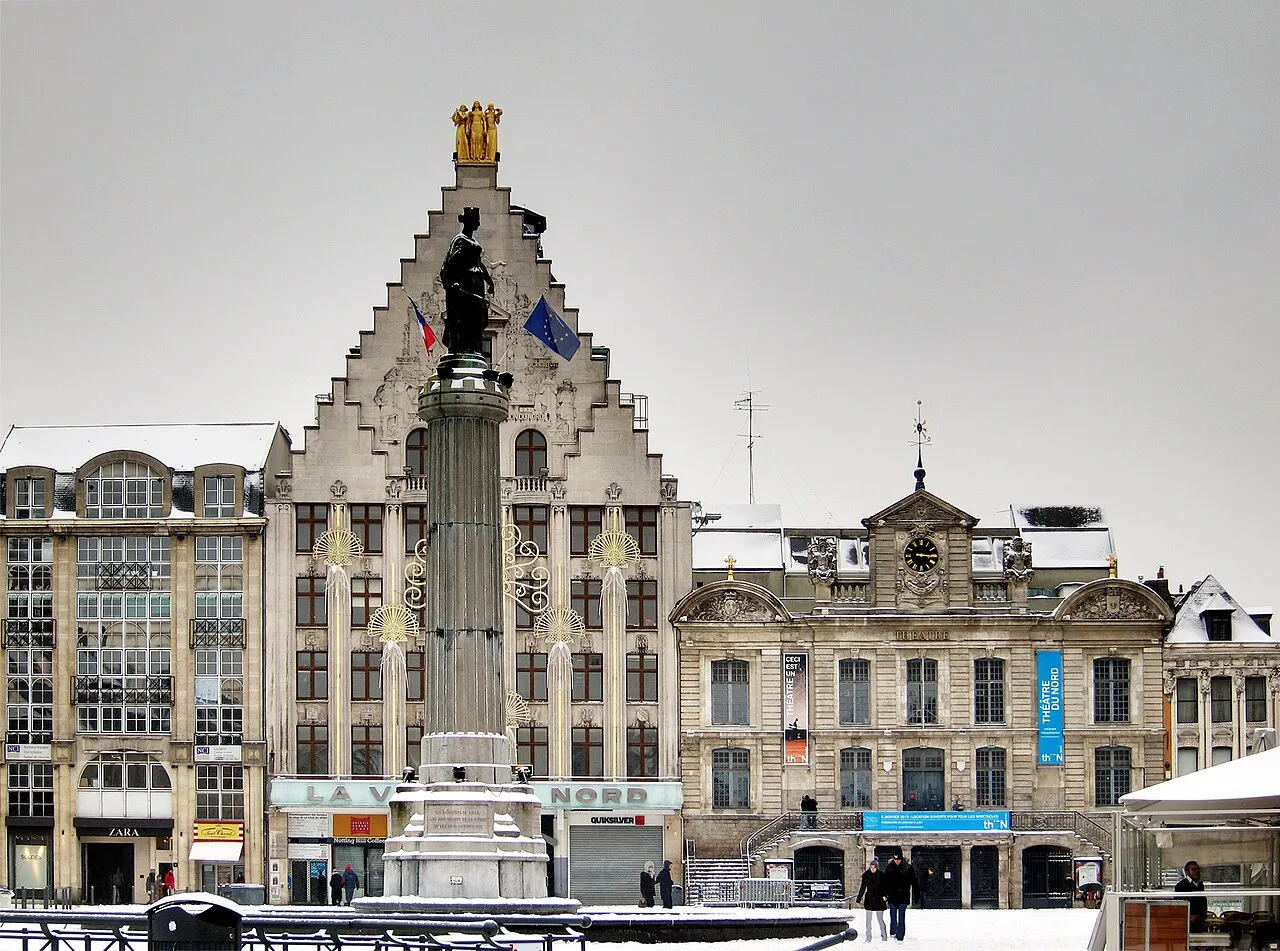Column of the Goddess and stepped-gable facades on a snowy Grand Place, Lille
