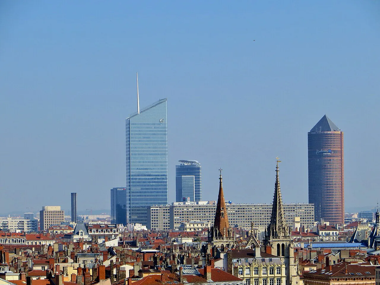 Part-Dieu skyscrapers rising behind the rooftops and church spires of central Lyon