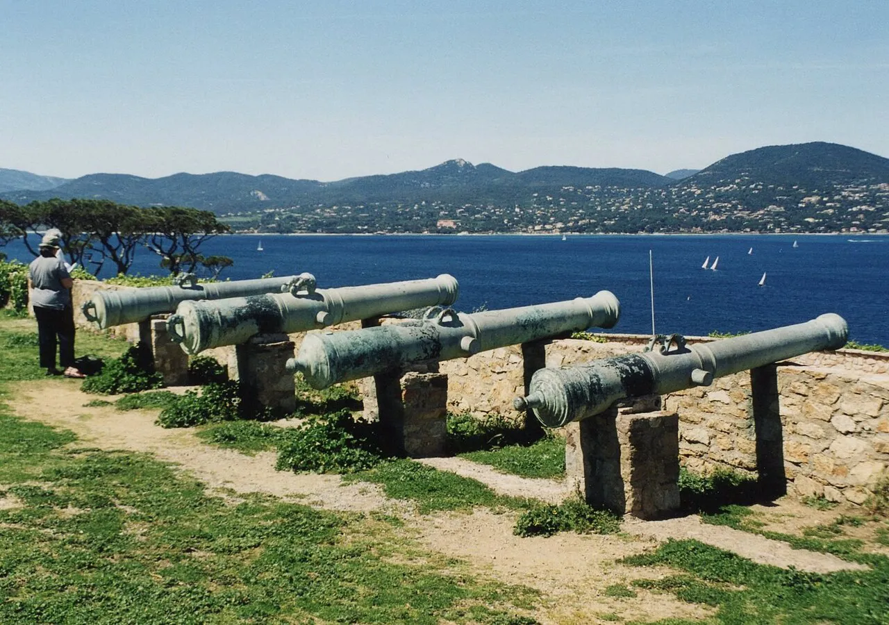 Old cannons on the ramparts of the Saint-Tropez citadel looking across the blue gulf to the hills