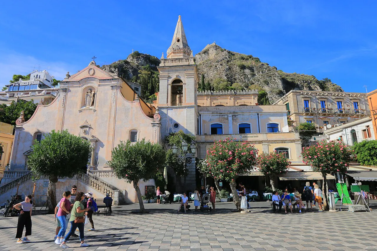 Piazza IX Aprile in Taormina with the Church of San Giuseppe and the rocky hillside behind