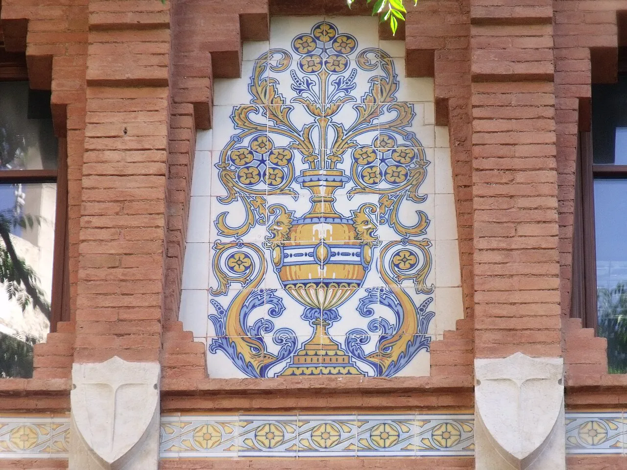 Blue and yellow ceramic tile panel set in red brick on the exterior of Valencia's Mercado Central