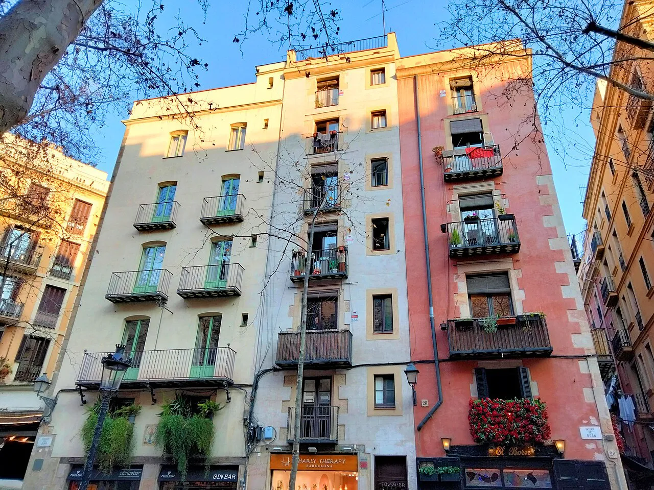 Pastel-coloured old apartment facades with balconies on Passeig del Born, Barcelona