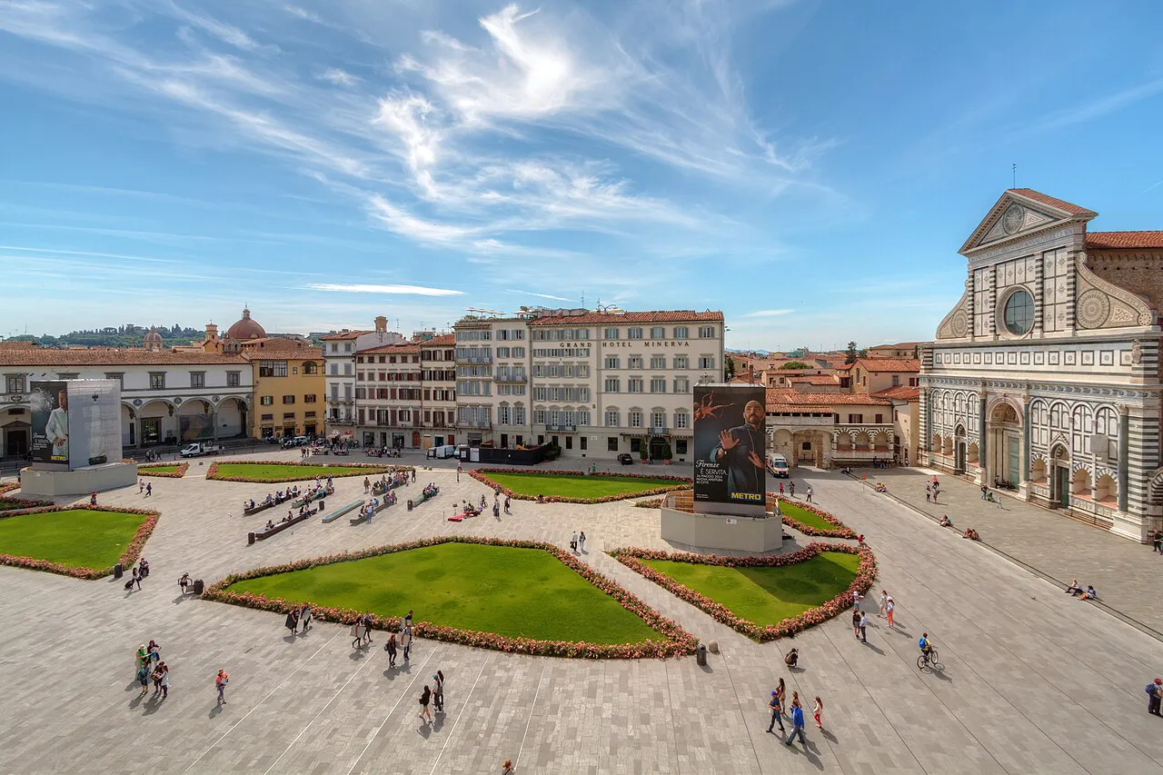 Elevated view over Piazza Santa Maria Novella in Florence, its lawns and the basilica facade at right