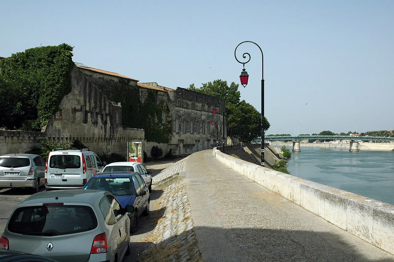 Cars parked along the Quai Marx Dormoy beside the Rhône in Arles on a sunny day