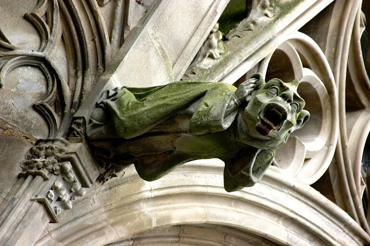 Close-up of a moss-tinged Gothic gargoyle on the Basilique Saint-Nazaire in the Cité de Carcassonne