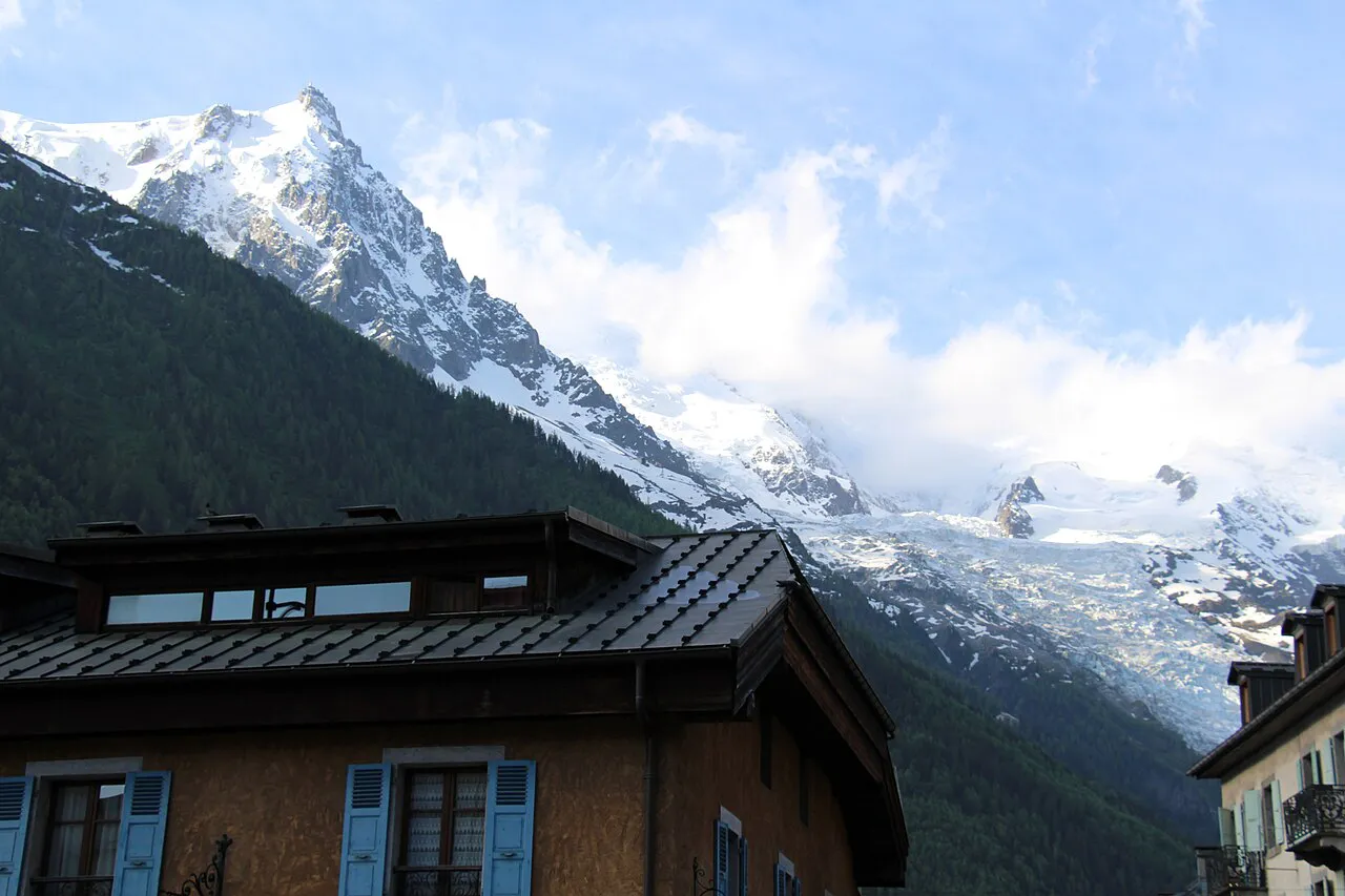 The Aiguille du Midi and the Bossons glacier rising above wooden rooftops in Chamonix town