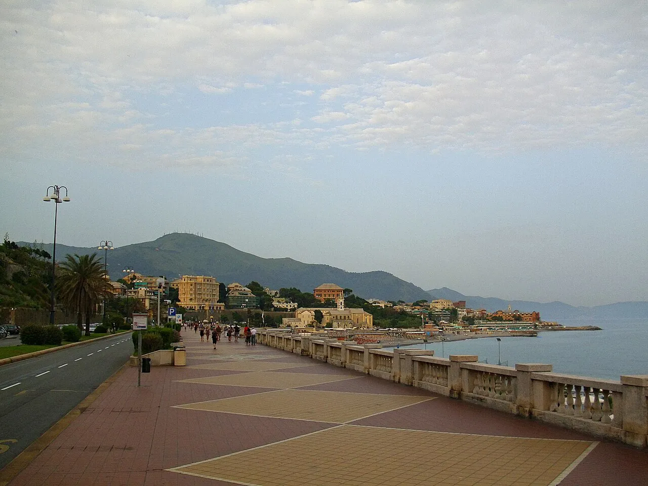 Wide seafront promenade of Corso Italia in Genoa with the coast and hills beyond