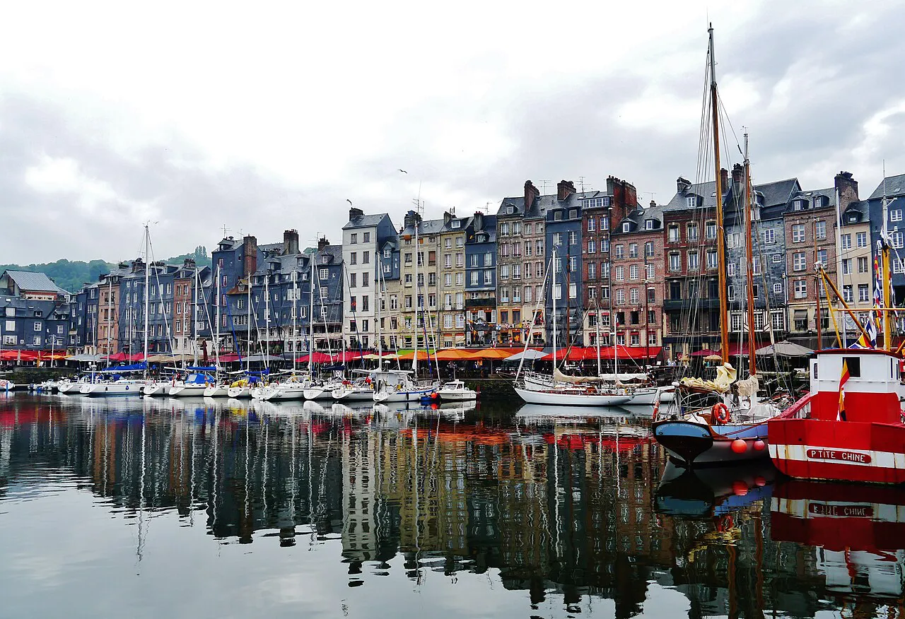 Tall slate-fronted houses of Quai Sainte-Catherine reflected in the Vieux Bassin harbour, Honfleur