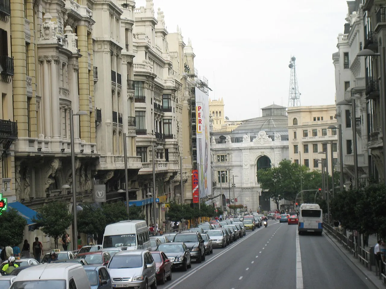 Daytime view down Gran Vía in Madrid with ornate early-20th-century façades and traffic