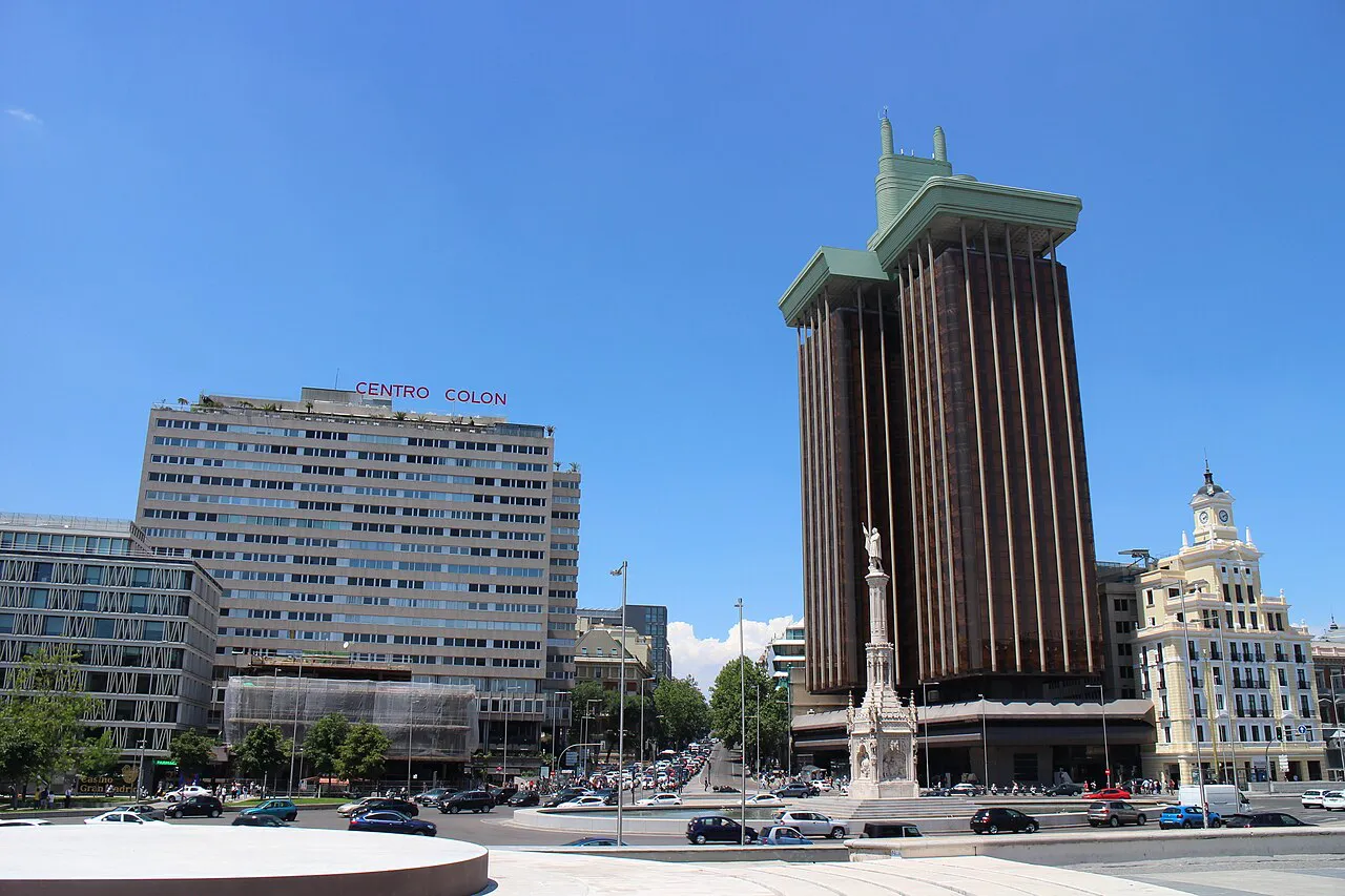 Plaza de Colón in Madrid with the Columbus monument and the twin Torres de Colón under a blue sky