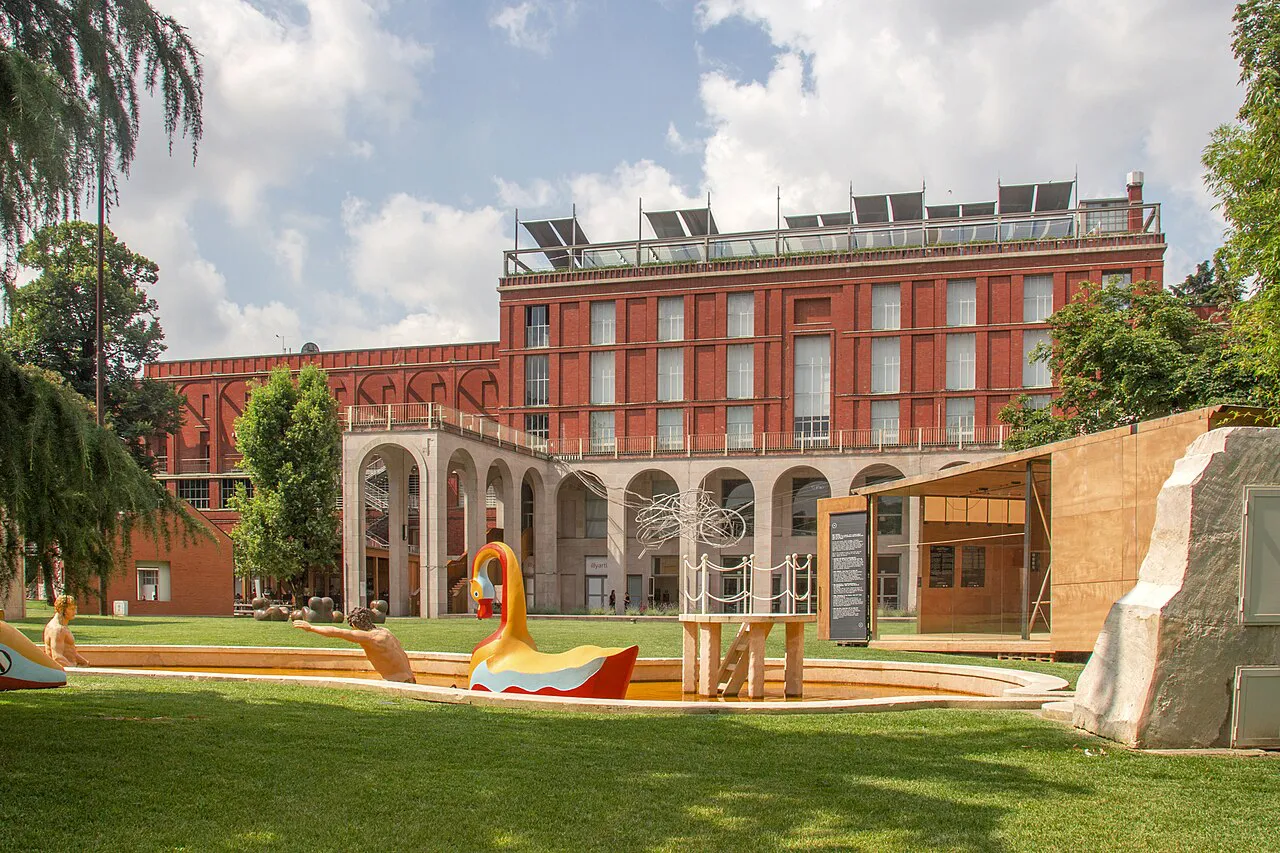Red-brick Palazzo dell’Arte in Parco Sempione, Milan, with De Chirico’s Bagni Misteriosi fountain in front
