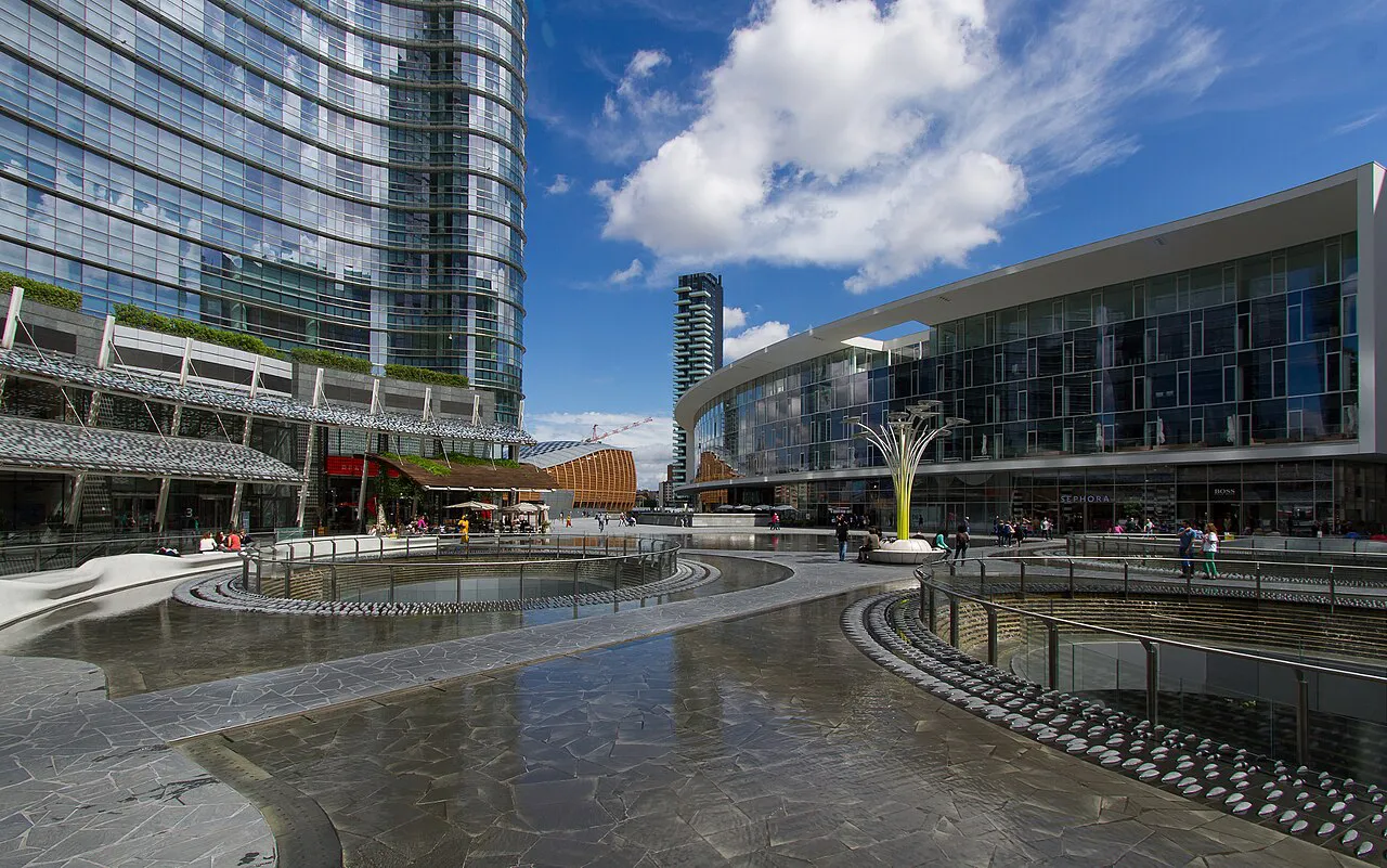 Shallow fountain pools of Piazza Gae Aulenti in Milan, ringed by glass towers in Porta Nuova