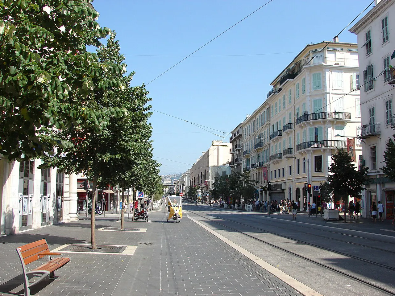 Tree-lined Avenue Jean-Médecin in central Nice with tram tracks and period apartment buildings