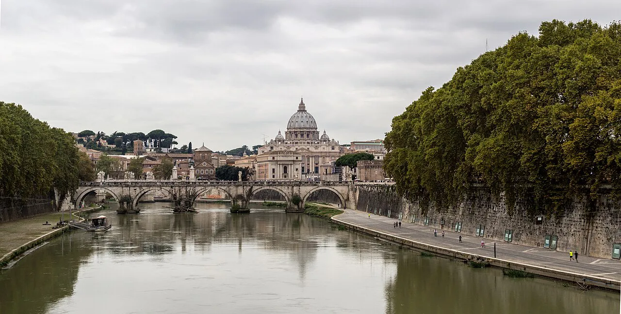 The Tiber and Ponte Sant'Angelo with the dome of St Peter's Basilica beyond, Rome, on an overcast day