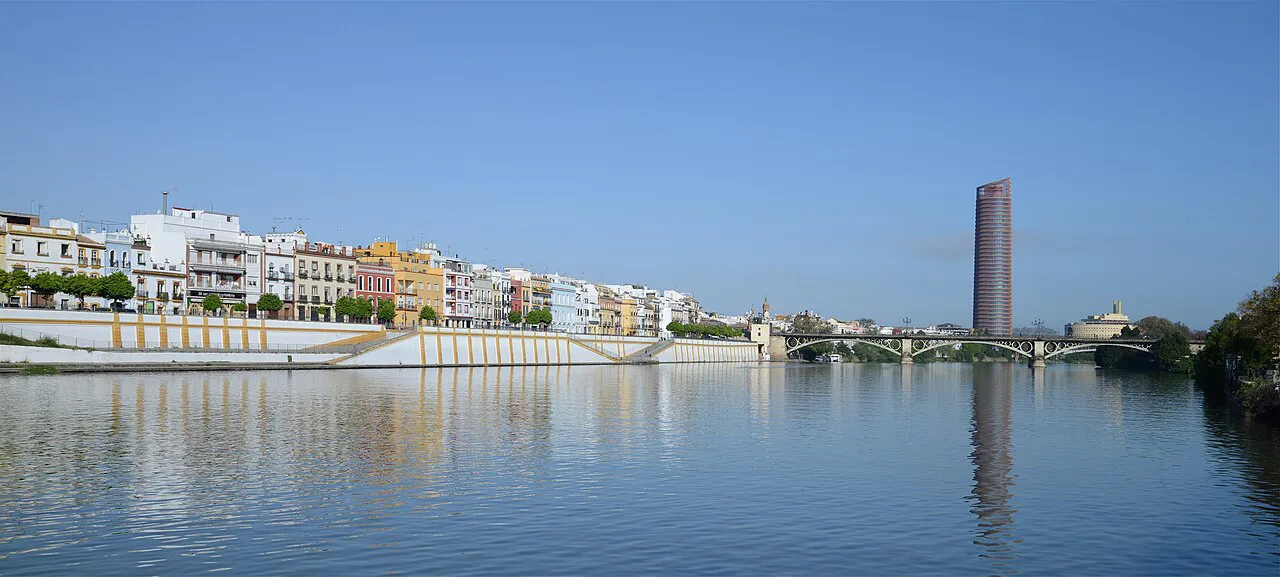 Colourful houses of Triana along Calle Betis reflected in the Guadalquivir river, Seville