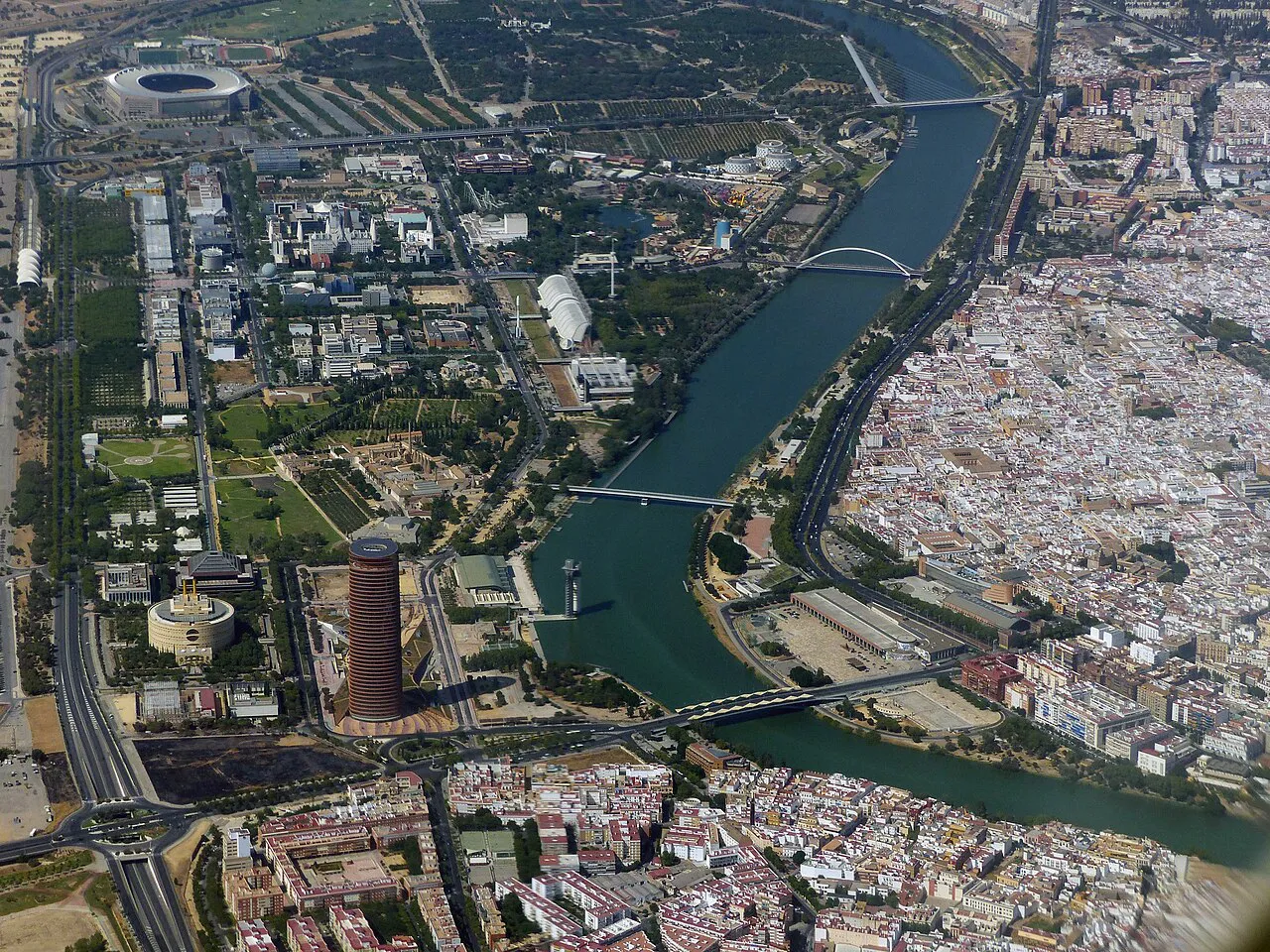 Aerial view of Seville with the Guadalquivir river, its bridges and the city spreading on both banks