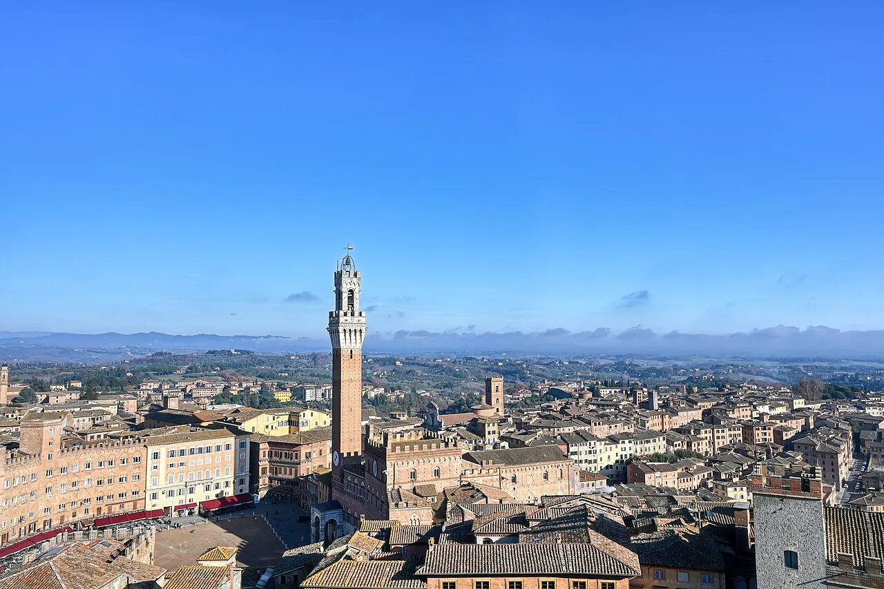 Panorama over Siena's terracotta rooftops to the Torre del Mangia and the Tuscan hills