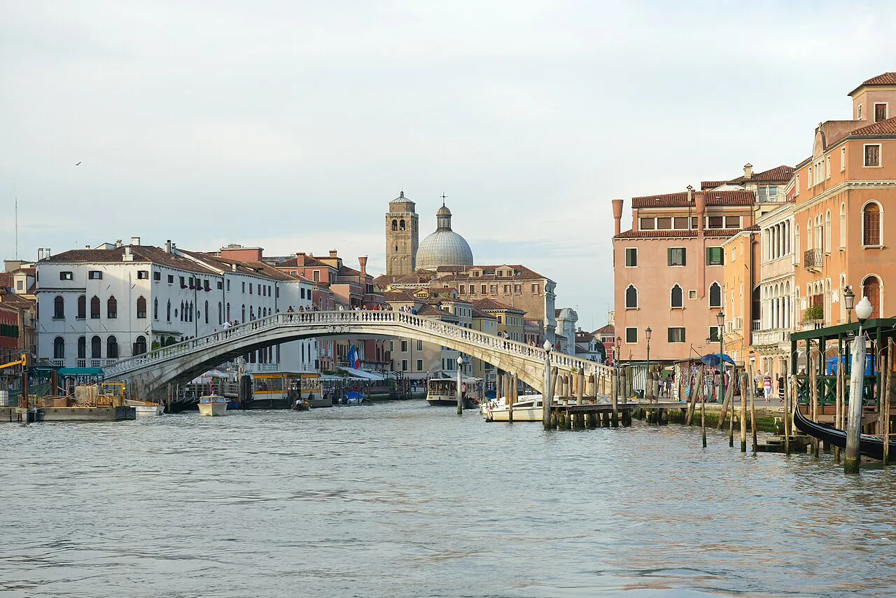 Stone arch of the Ponte degli Scalzi over the Grand Canal in Venice, with San Simeone Piccolo dome behind