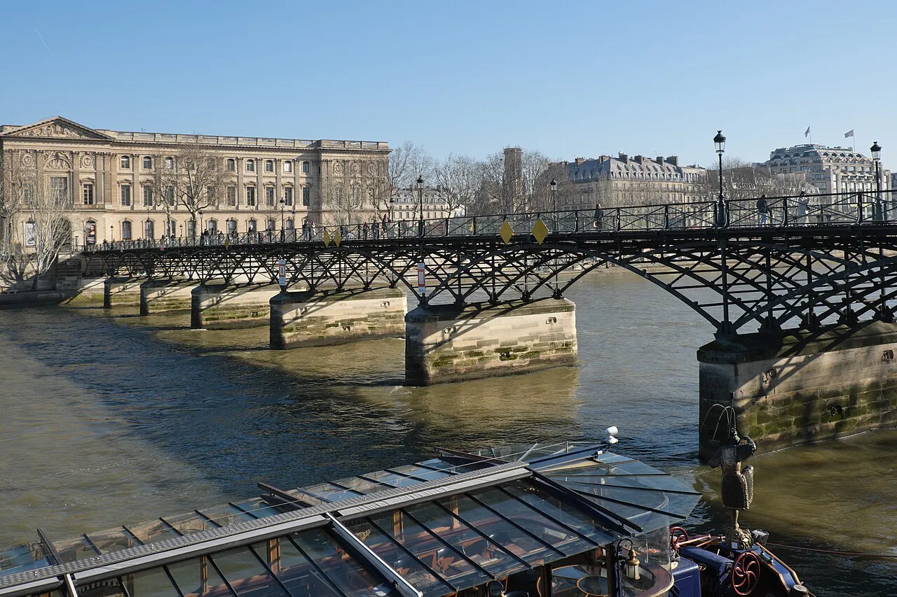 Pont des Arts footbridge over the Seine leading towards the Louvre Palace, Paris
