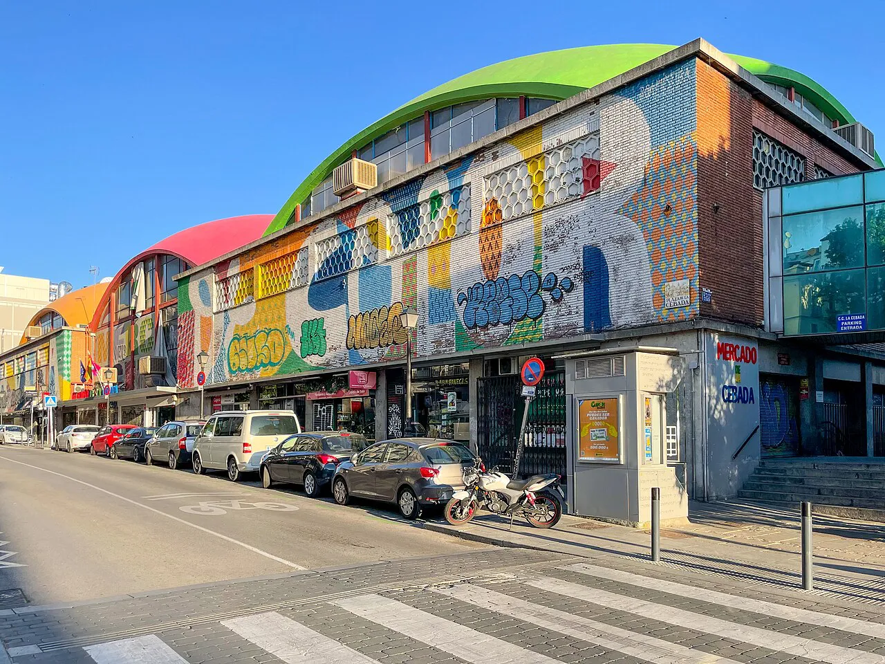 Mural-covered exterior and domed roofs of the Mercado de la Cebada market hall in La Latina, Madrid