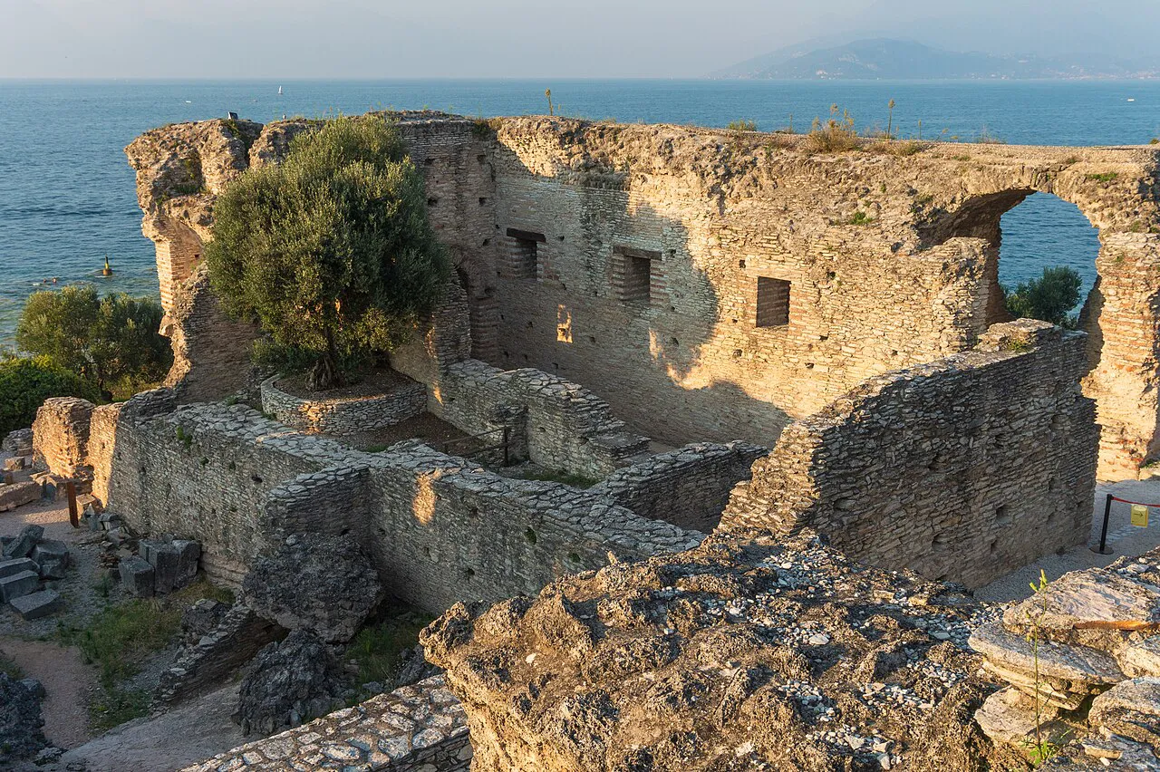 Stone ruins of the Roman villa at the Grottoes of Catullus with Lake Garda behind, Sirmione peninsula