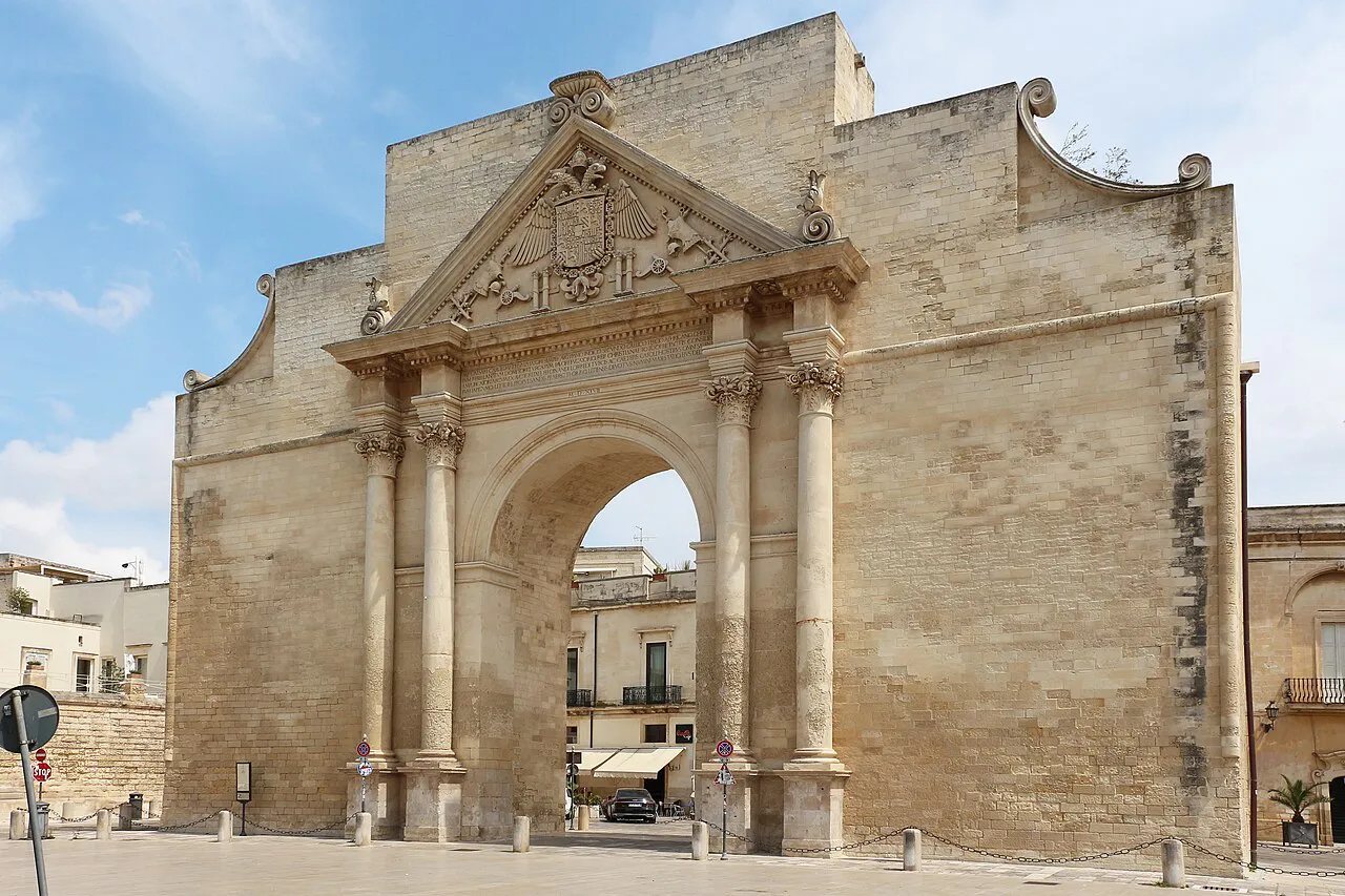 Porta Napoli, Lecce's triumphal arch city gate in pale limestone, under a blue sky