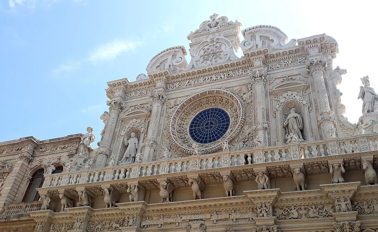 Ornate Baroque upper facade and rose window of the Basilica di Santa Croce in Lecce