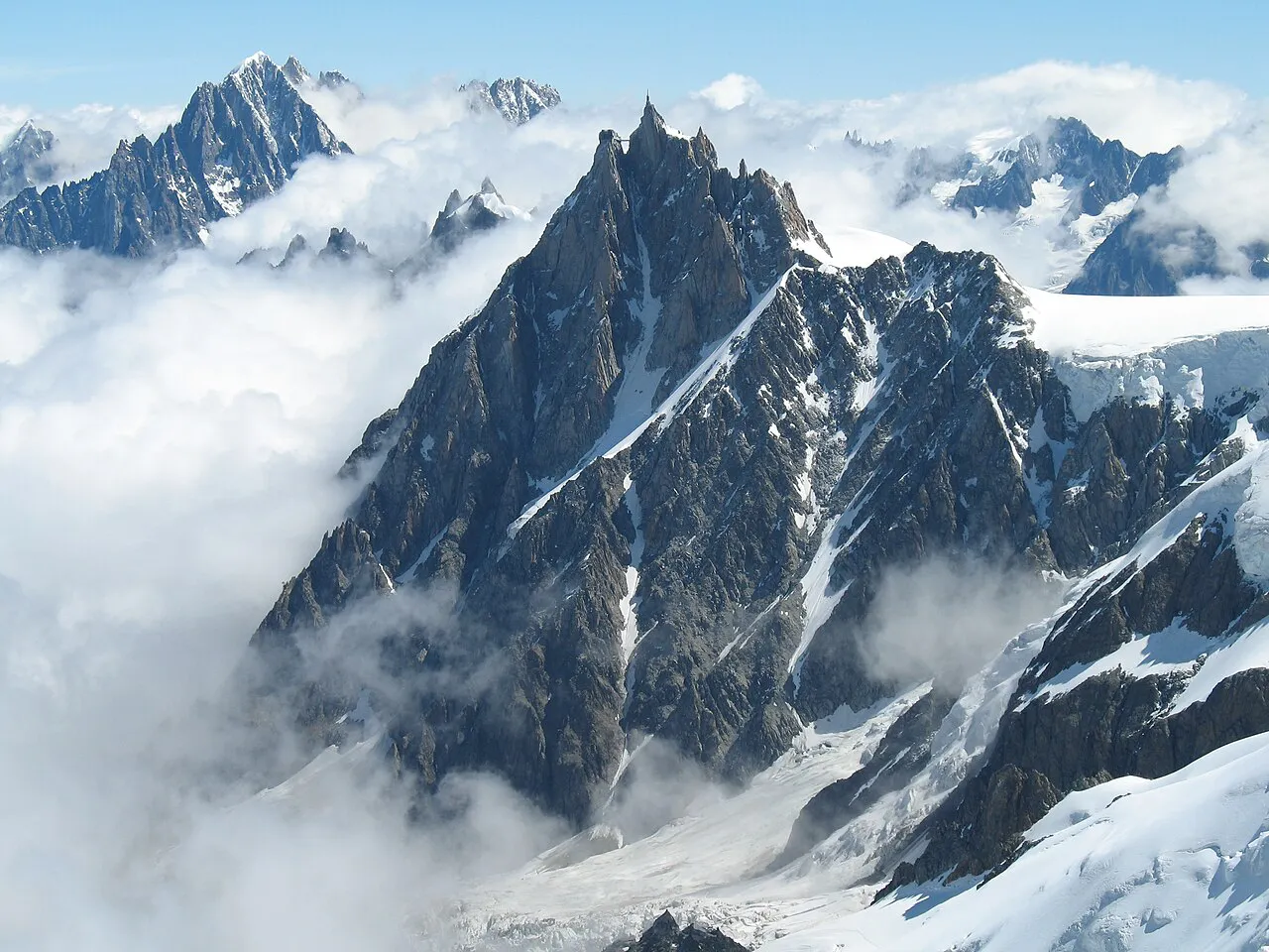 The Aiguille du Midi needle rising above a sea of cloud in the Mont Blanc massif above Chamonix