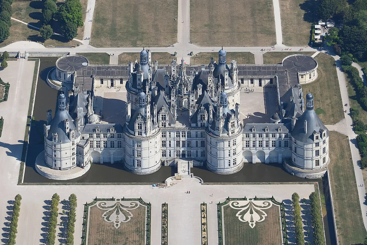 Aerial view of the Château de Chambord with its towers, formal gardens and moat