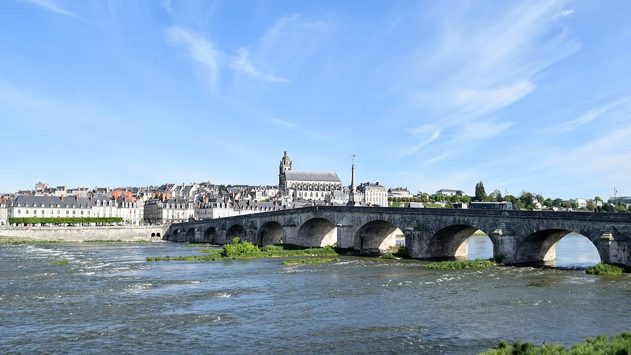 The stone arches of Pont Jacques-Gabriel spanning the Loire in front of the Blois skyline and its cathedral