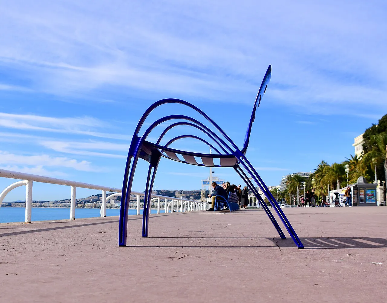 Giant blue chair sculpture on the Promenade des Anglais beside the sea in Nice