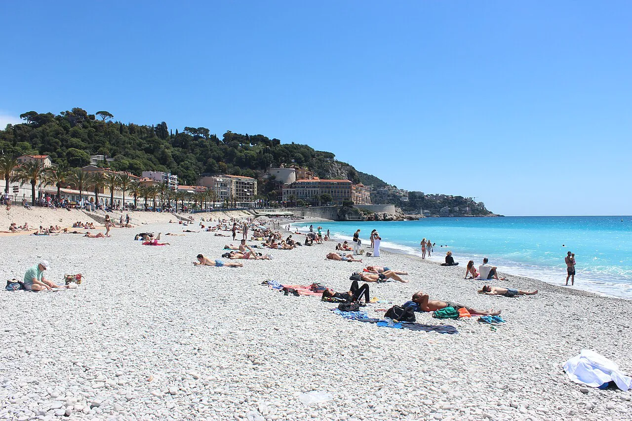 White pebble beach and turquoise sea of Nice looking east towards Castle Hill