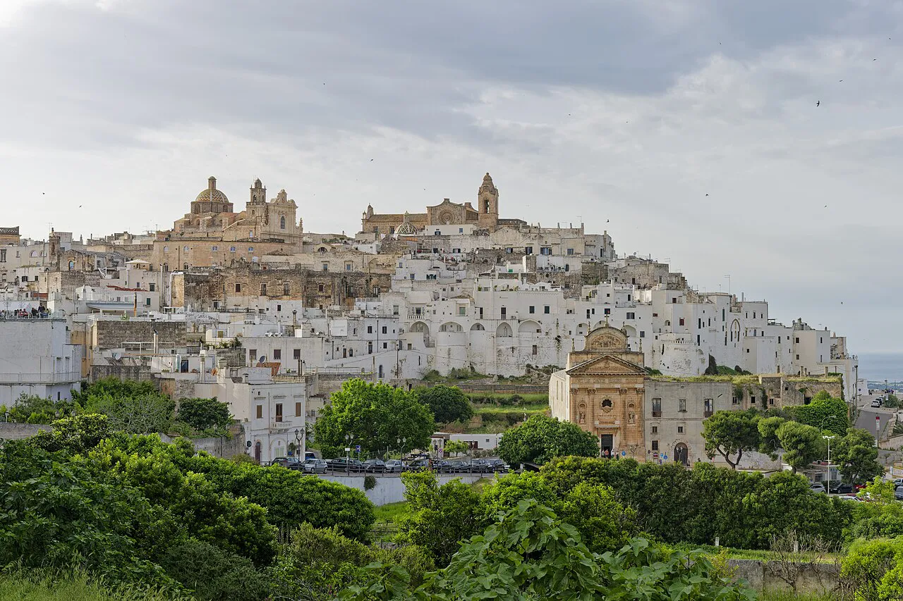 Ostuni’s white hilltop old town and cathedral rising above green gardens