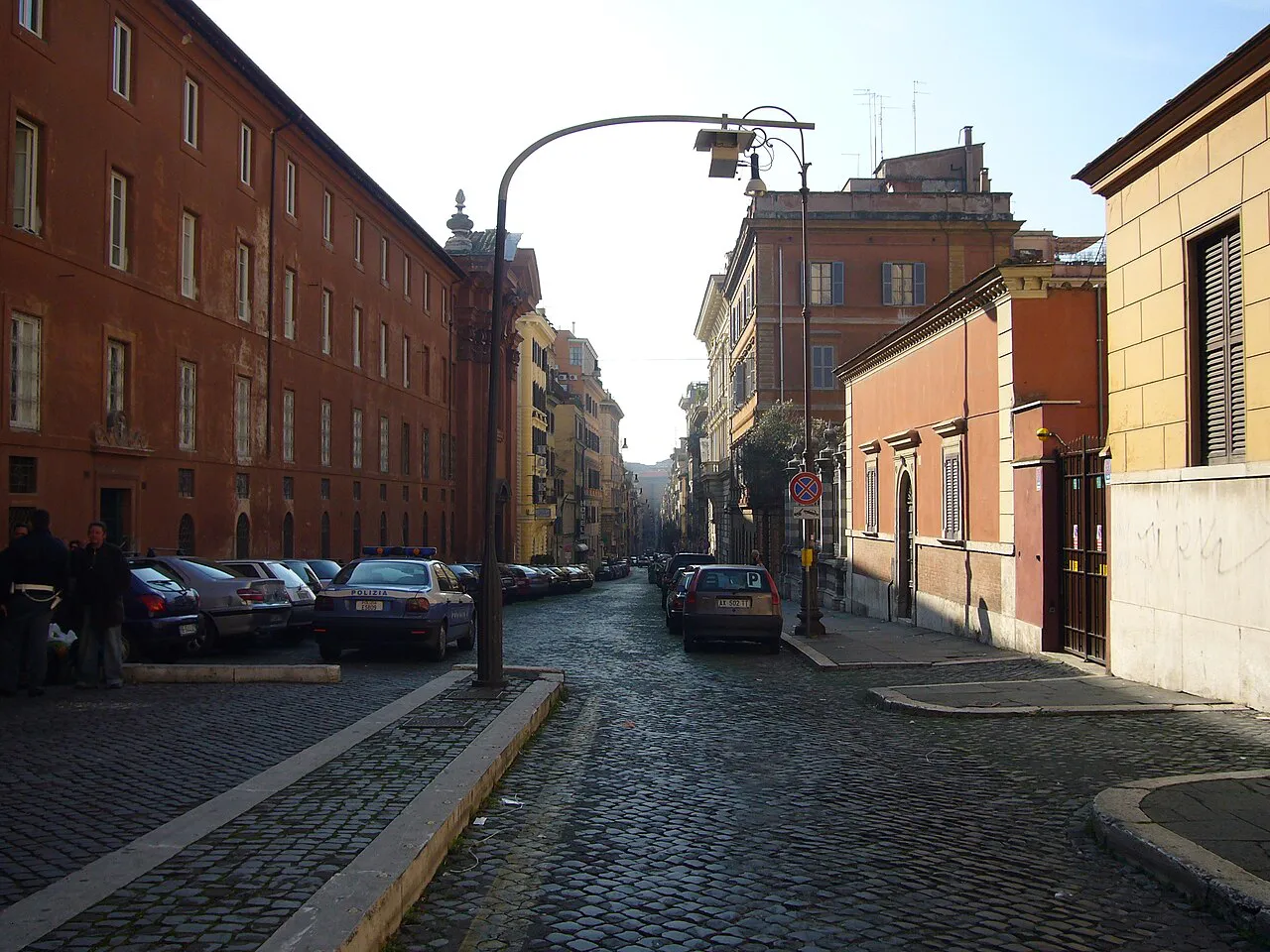Cobbled Via Urbana in the Monti district of Rome, lined with brick and ochre buildings