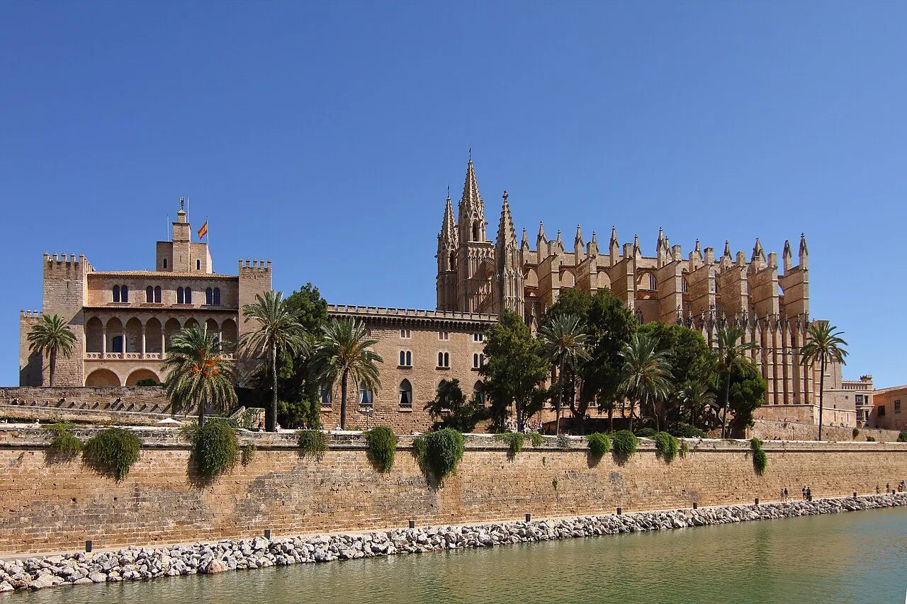 The Royal Palace of La Almudaina and Palma Cathedral above the old sea wall and lake