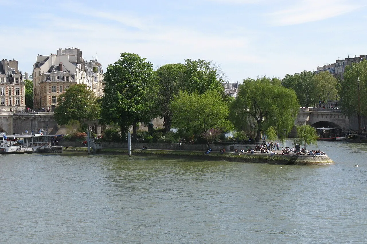Willow-lined tip of the Square du Vert-Galant on the Île de la Cité, seen across the Seine in Paris
