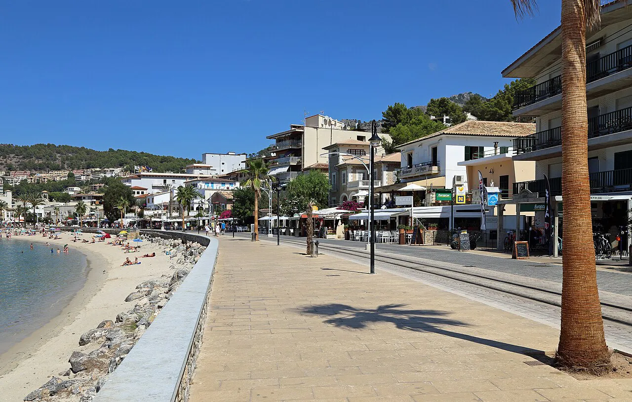 Palm-lined seafront promenade beside the sandy beach at Port de Sóller, Mallorca