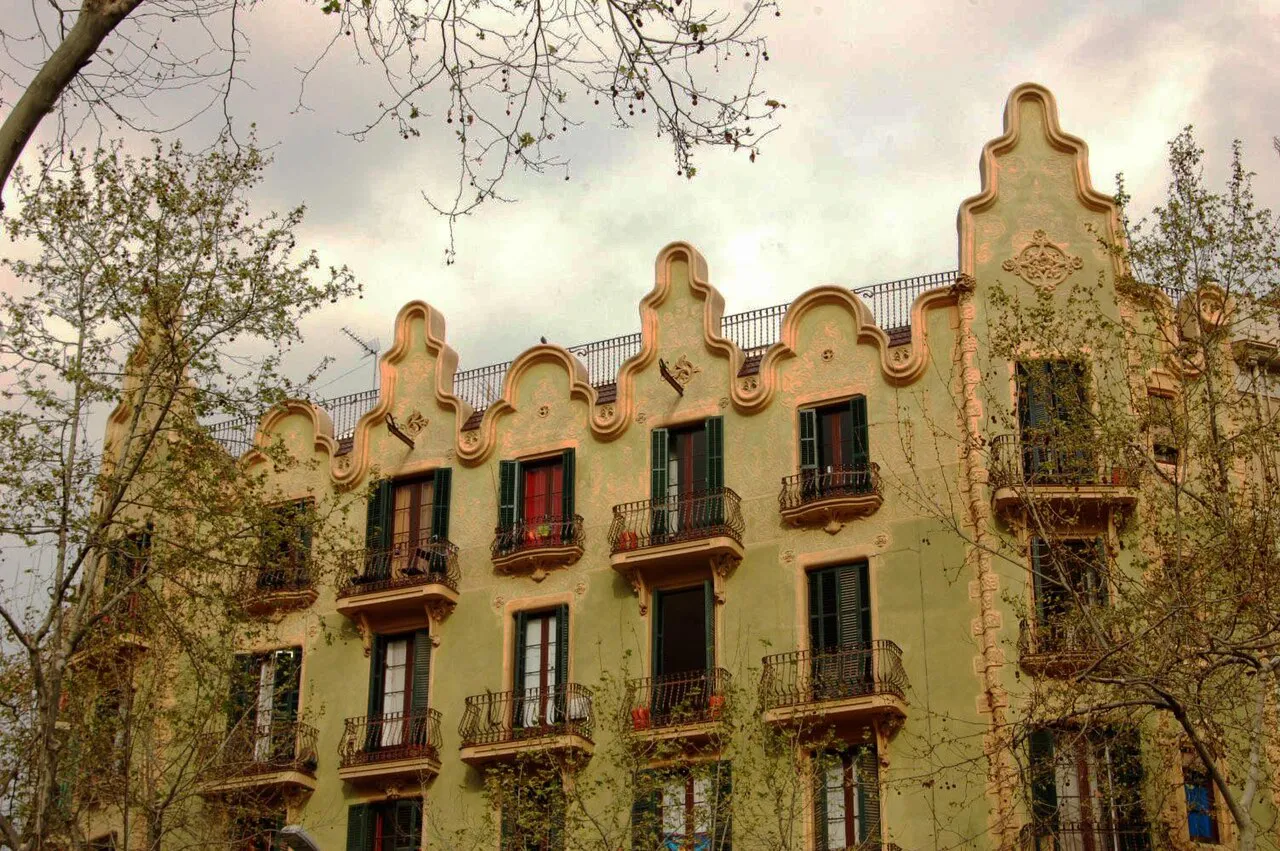 Ornate modernista apartment building with curved gables and balconies on Rambla del Poblenou, Barcelona