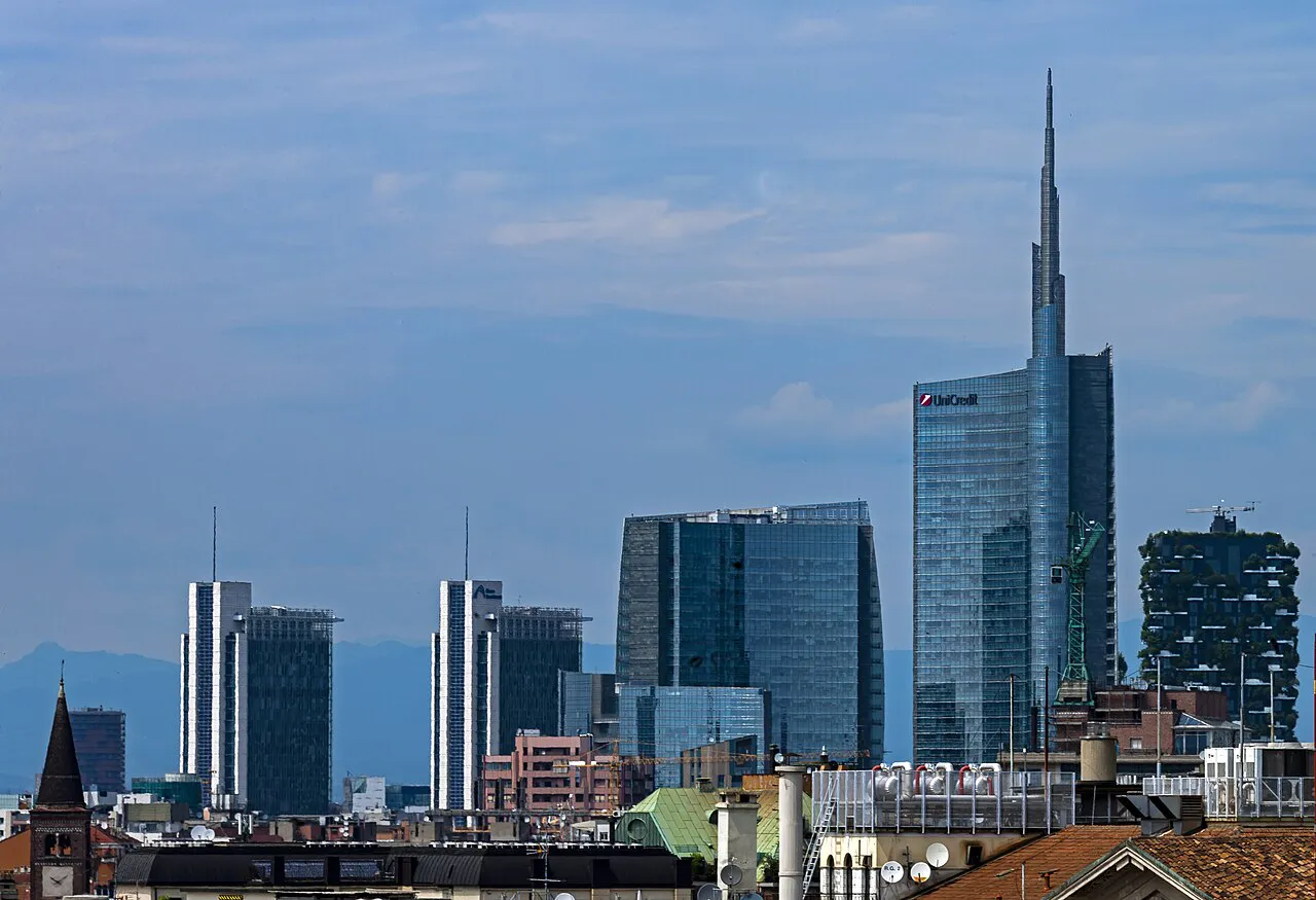 Milan rooftops with the Porta Nuova skyline, including UniCredit Tower and Bosco Verticale, behind