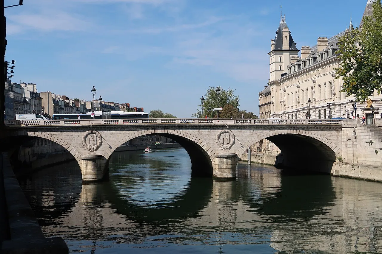 Stone arches of Pont Saint-Michel over the Seine on a sunny day, Paris