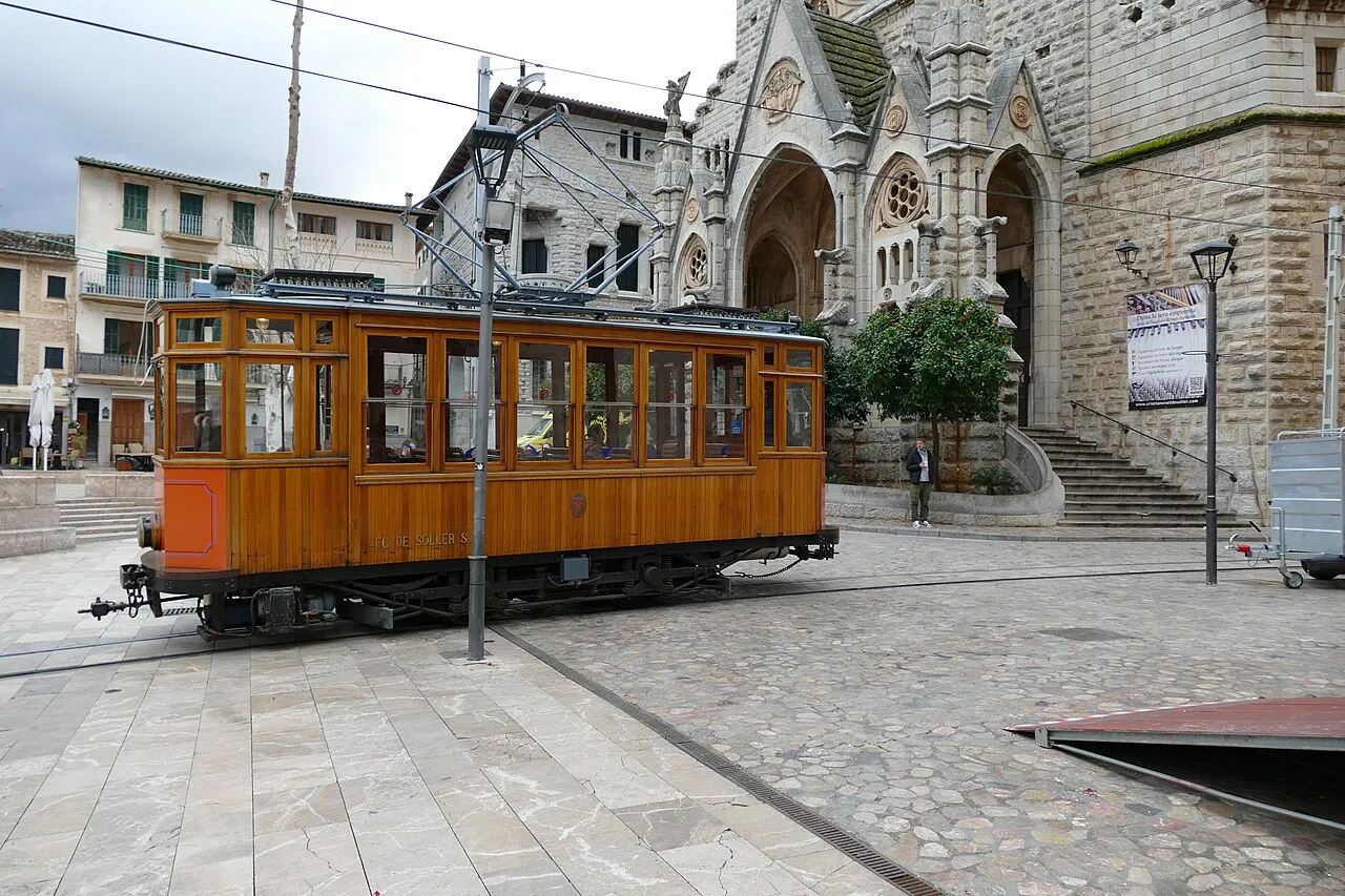 Wooden Sóller tram on Plaça de la Constitució beside the church of Sant Bartomeu in Sóller town