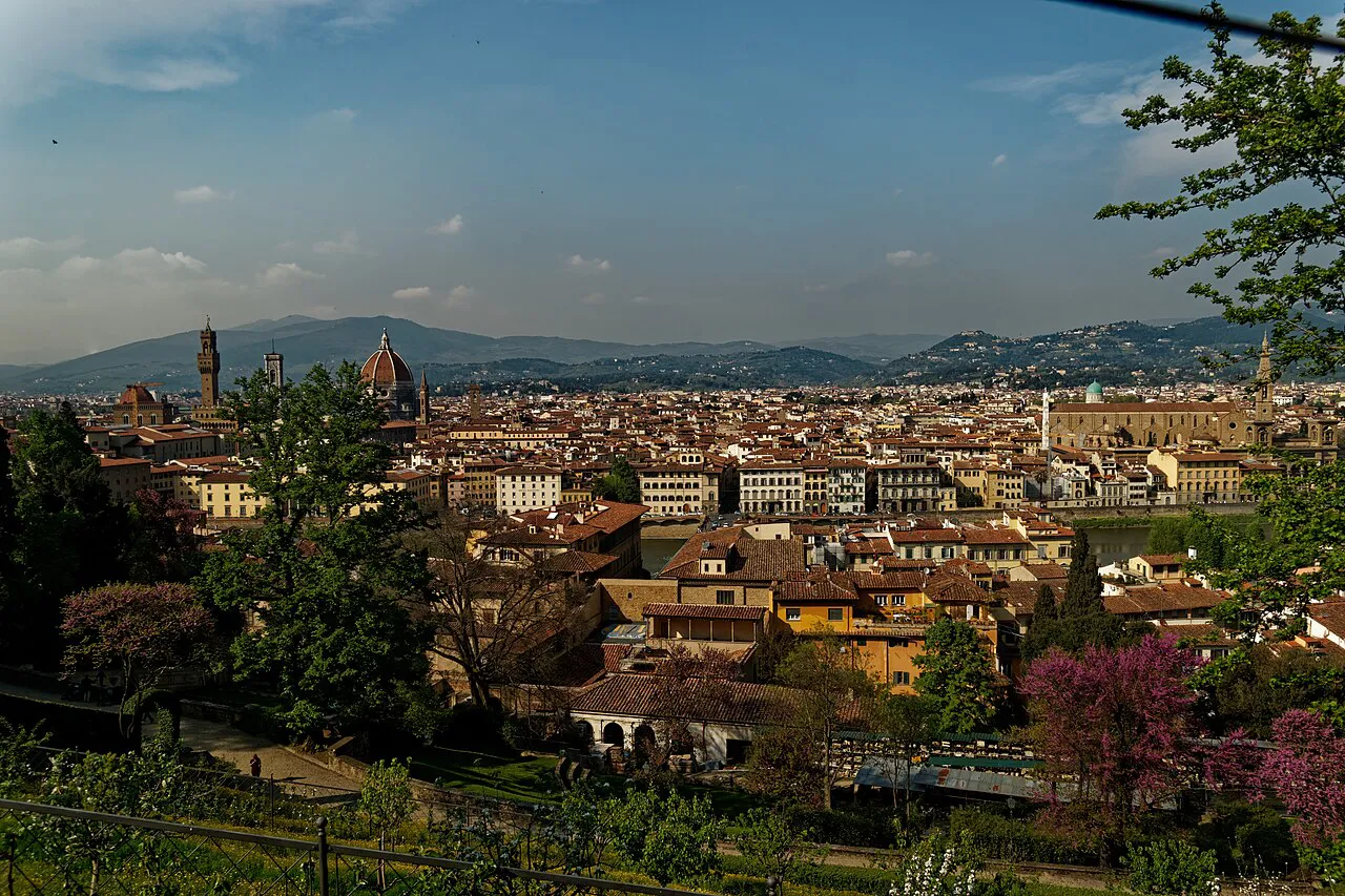 Florence rooftops, the Duomo and Palazzo Vecchio tower seen across flowering trees from the Bardini Garden