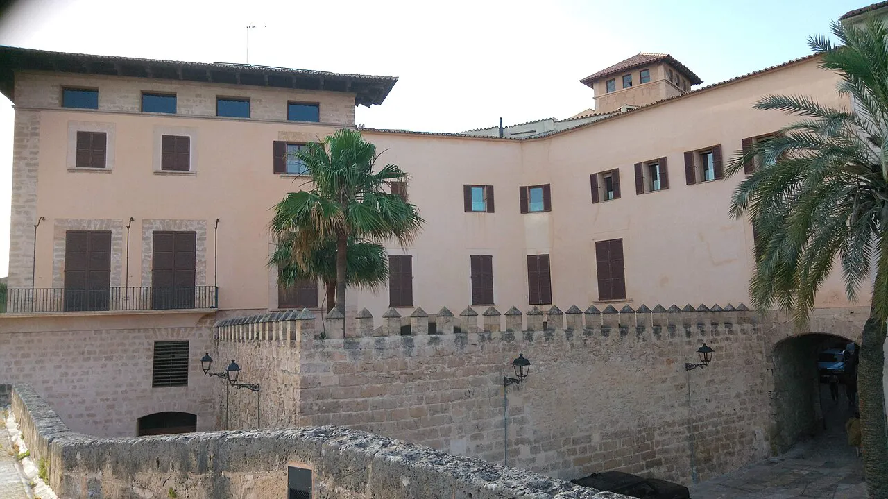 Pale stone mansion with palm trees above the old city wall on Dalt Murada in Palma’s old town