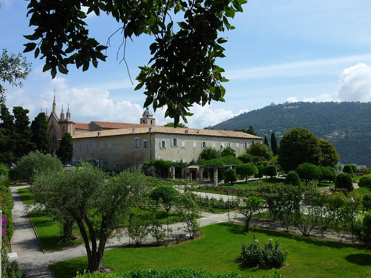 Cimiez Monastery and its olive-tree gardens below wooded hills in Nice