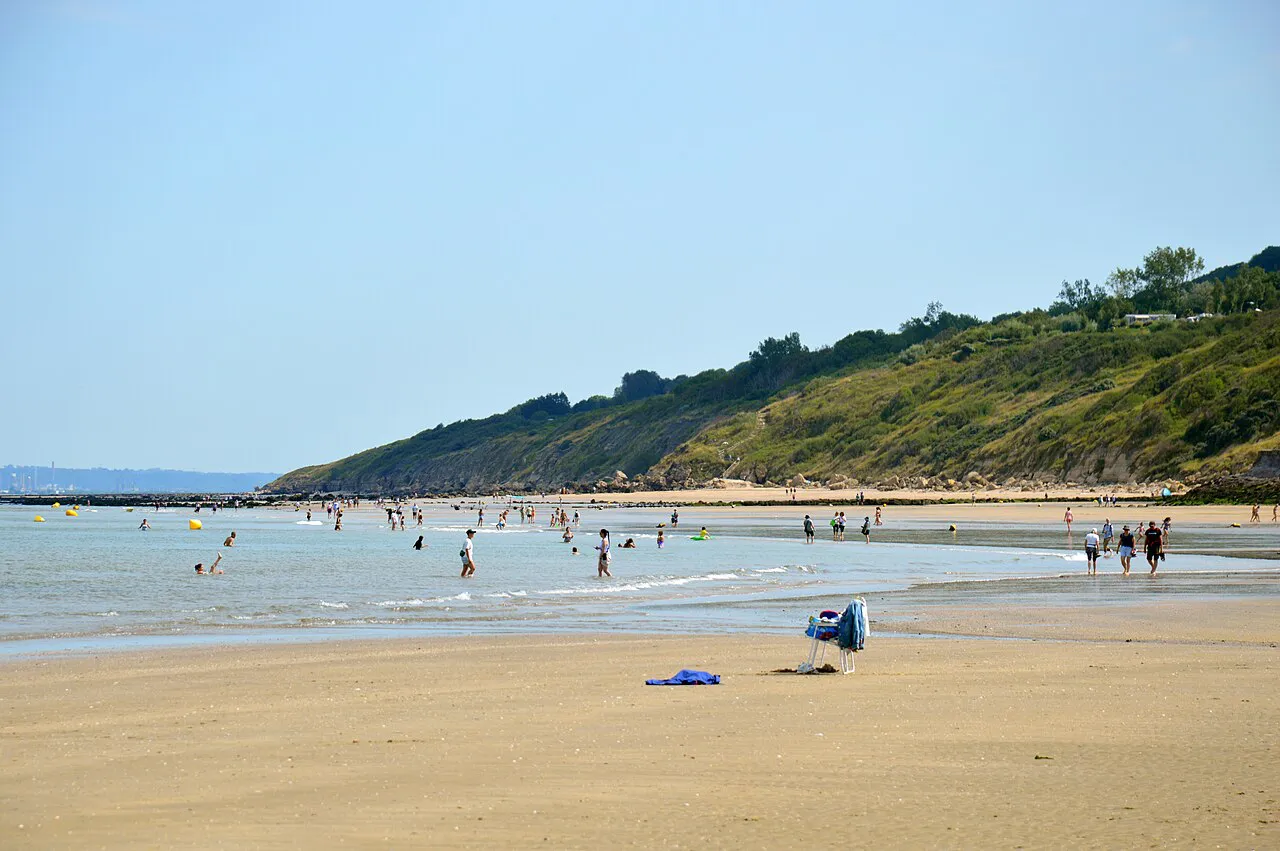 Trouville-sur-Mer beach at low tide looking toward the green Roches Noires headland