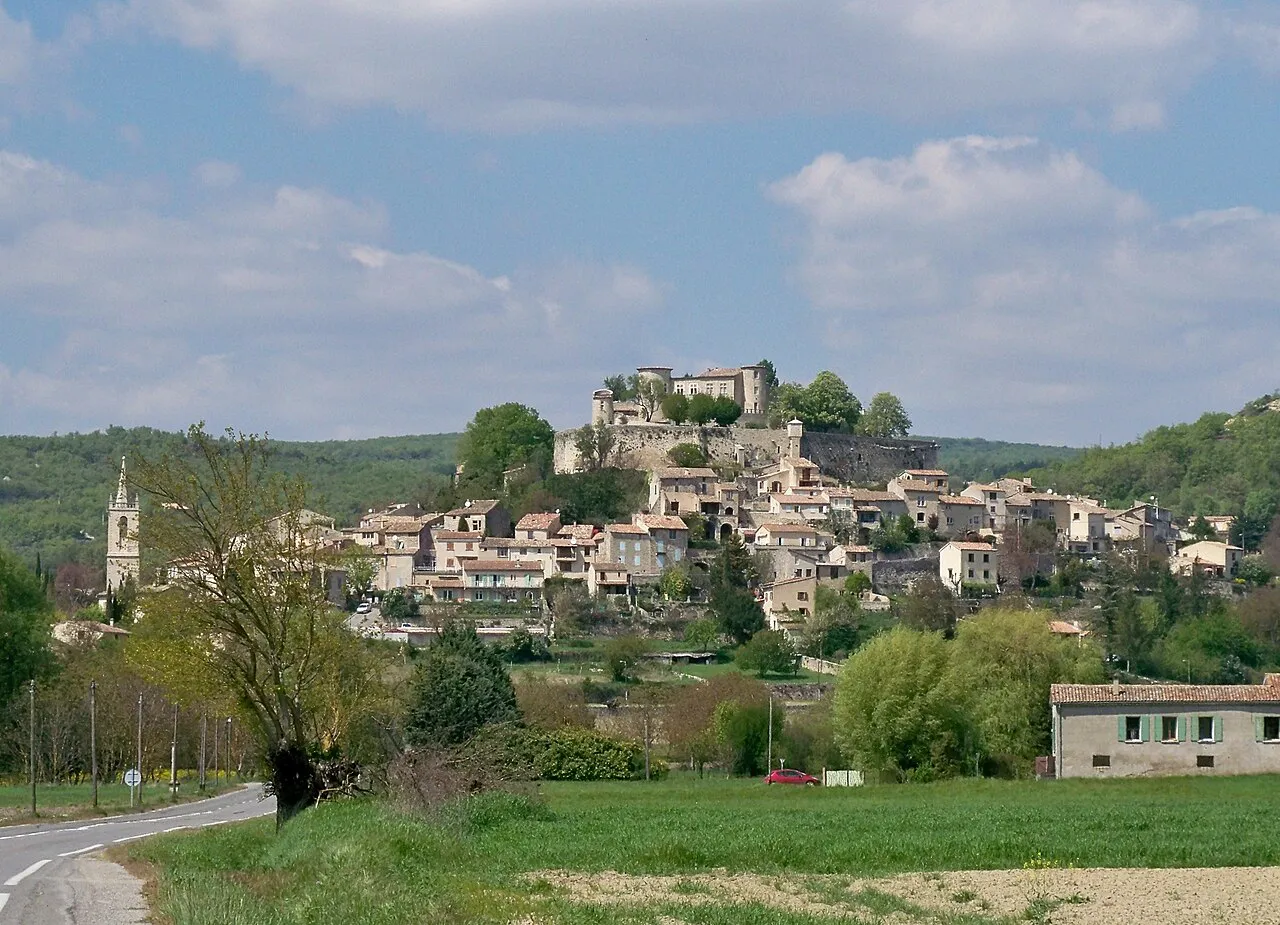 Hillside village of Mane with stone houses climbing to its castle, Alpes-de-Haute-Provence
