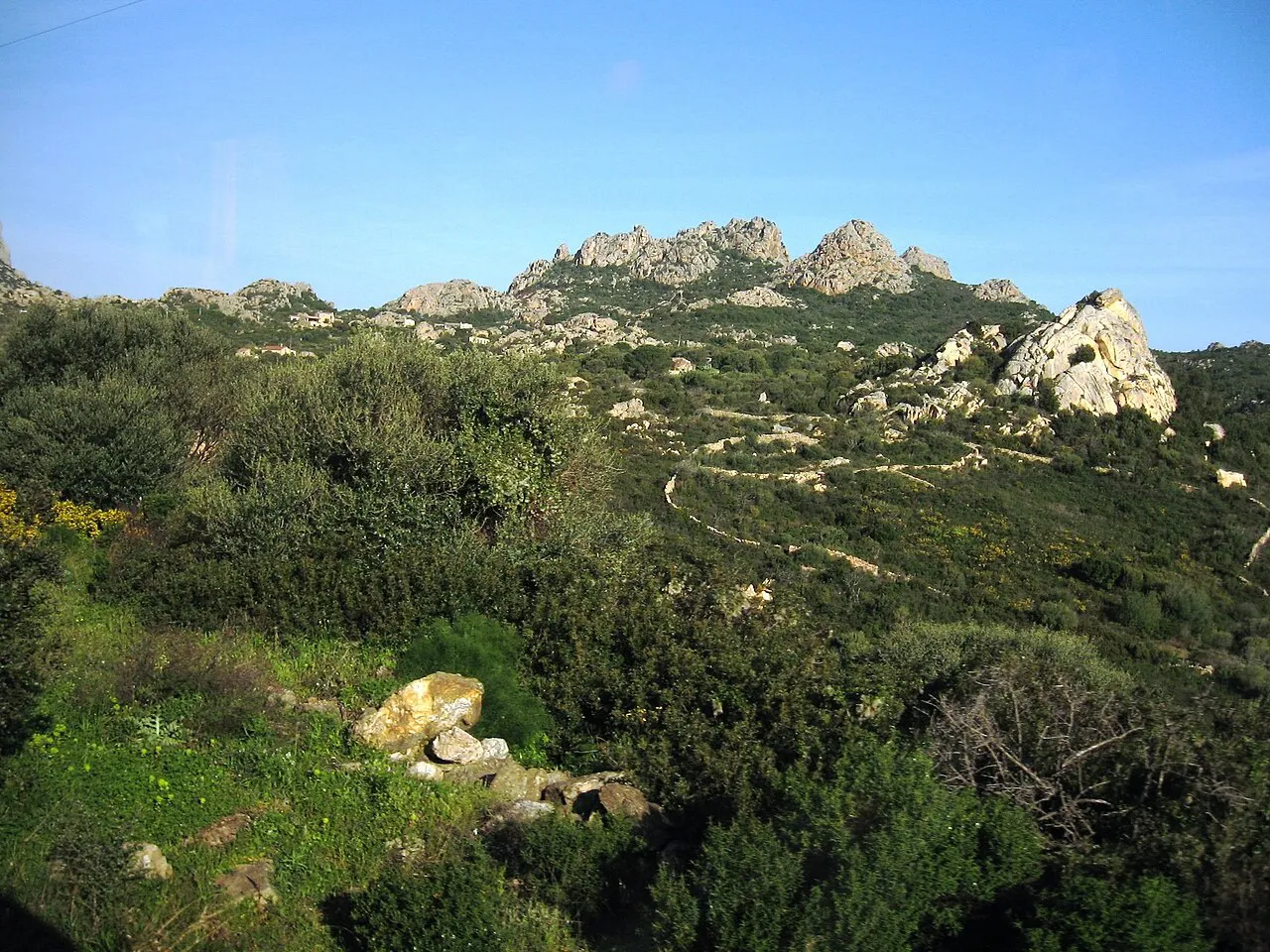 Granite outcrops and green maquis-covered hills on the Costa Smeralda near Porto Cervo