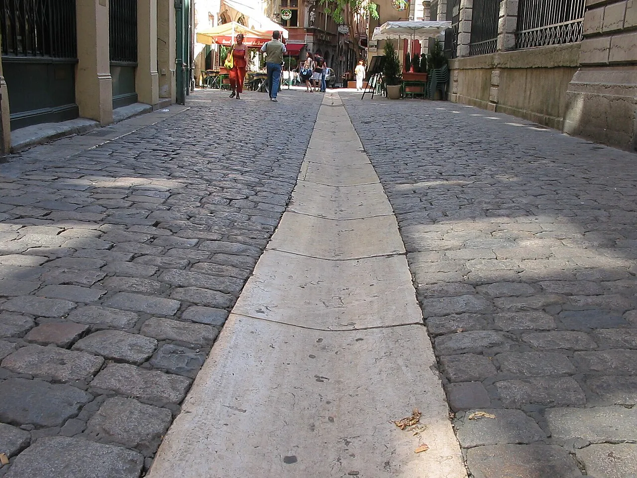 Cobbled Vieux Lyon street with a central stone gutter running between old buildings