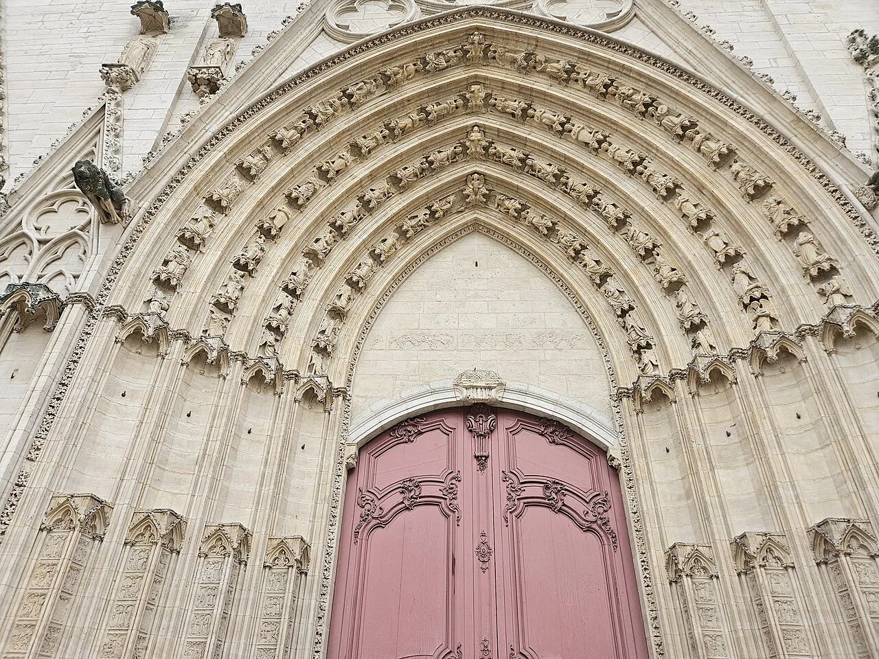 Carved Gothic west portal and red door of Saint-Jean Cathedral in Vieux Lyon