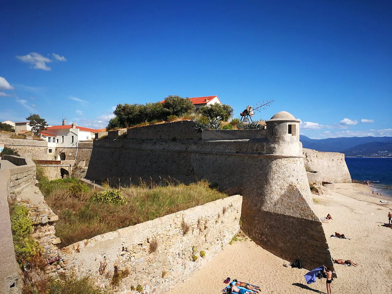 Stone bastion and bartizan of the Citadelle d'Ajaccio above the sandy Saint-François beach